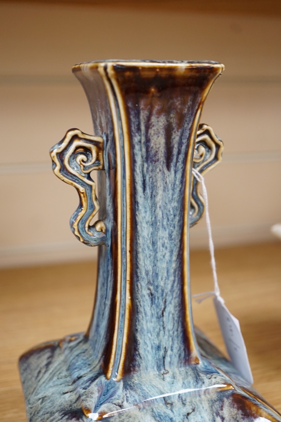 A Chinese Shiwan two handled vase, 23cms high